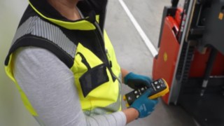 An employee operates a Linde Material Handling L03 EX explosion-proof high-lift truck using a remote control.