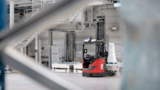 Automated R-MATIC reach trucks from Linde moving around the warehouse