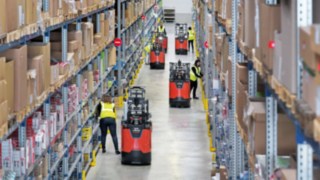 Employees work with new N20 series order pickers from Linde Material Handling in a warehouse.