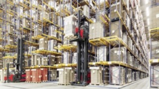 Two narrow-aisle K trucks from Linde Material Handling driving amongst high shelving