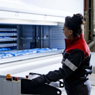 A service technician from Linde MH is operating the automated small-parts warehouse.