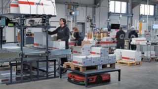 Linde MH’s C-MATIC automated mobile platform surrounded by a group of warehouse employees at ABS Safety.