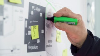 A CTL employee marks production routes on an outline.