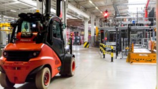 A forklift truck by Linde Material Handling waits at a Linde Safety Guard traffic light in the plant operated by Coca-Cola European Partners France.