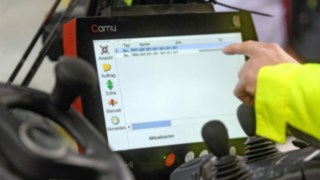 Warehouse worker from FLN touches the touchscreen 