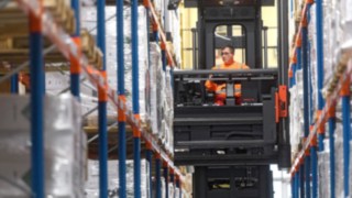 Employee uses a barcode scanner to check the distribution of the transport jobs