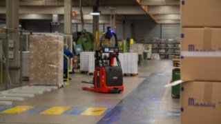 The autonomous L-MATIC pallet stacker from Linde Material Handling transporting pallets at Massilly.