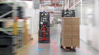 Two L-MATIC trucks from Linde Material Handling pass each other safely.