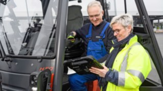 Two Schröder employees look at a tablet