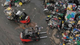 ic-trucks move the rubbish piles at the Willimantic recycling yard