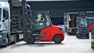 Electric forklift loads goods into the lorry.