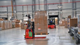 Automated industrial truck from Linde transports goods in the warehouse.