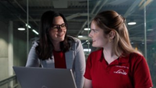 Two people are talking in an office