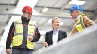 Linde employee in conversation with colleagues in the production