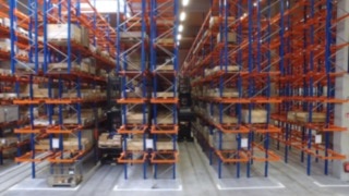 Linde very narrow aisle K truck in use between racks