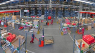 Warehouse with a large number of industrial trucks in use